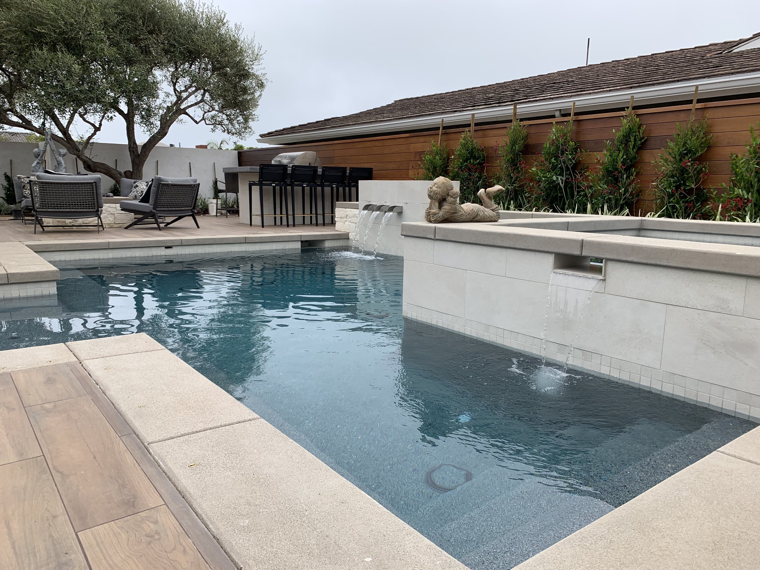 Modern pool with pergola and landscaping — JSQ Improvements backyard renovation Huntington Beach