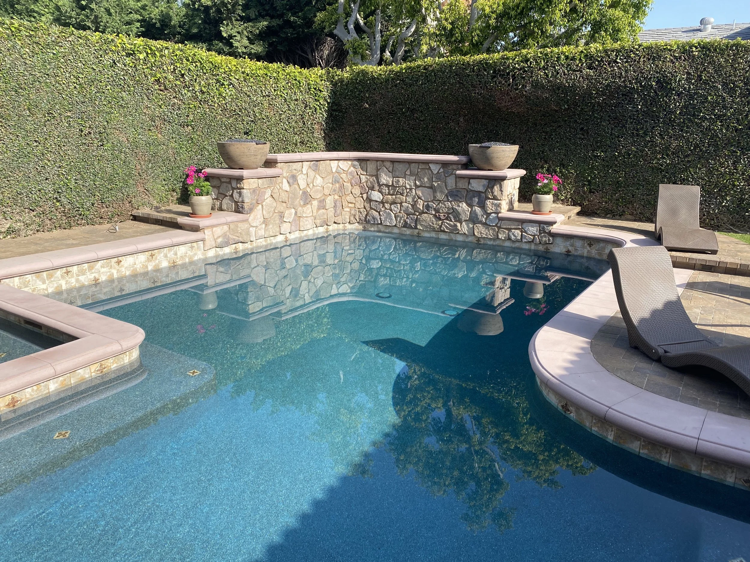 Crystal clear turquoise pool with waterfall — JSQ Improvements Huntington Beach pool builder